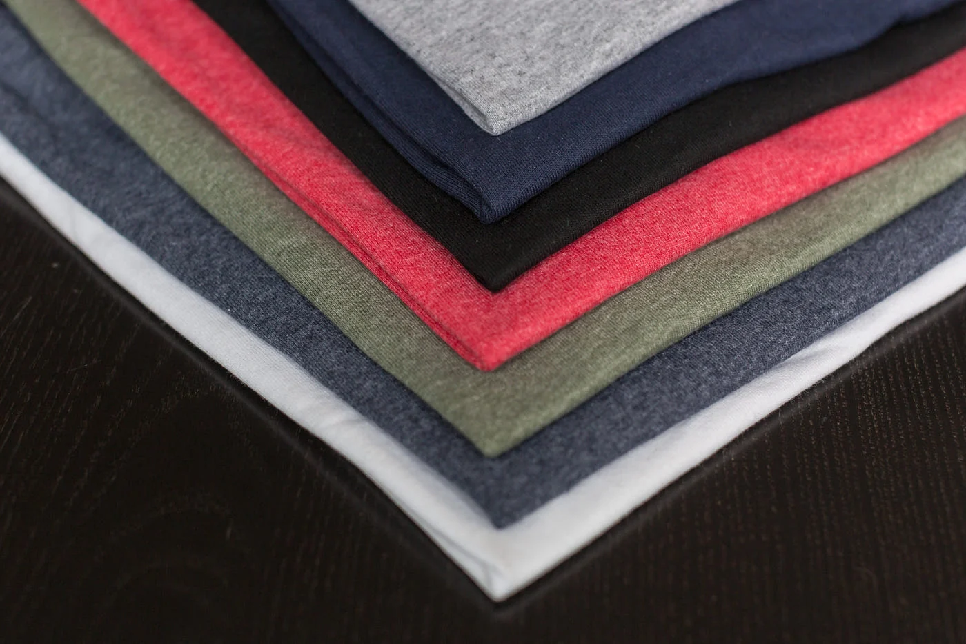 Folded jersey tees in grey marl, navy, madder and moss