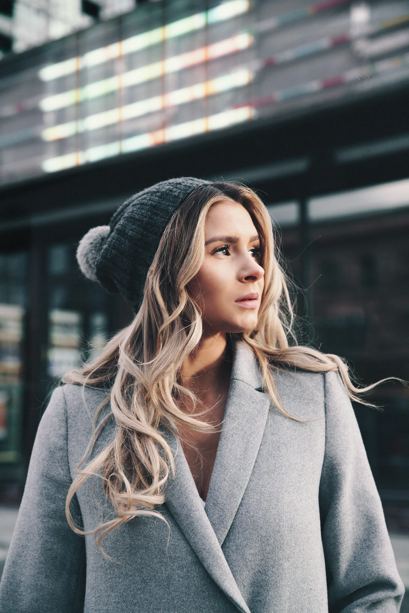 Woman in a dove grey double-faced wool coat and knitted hat