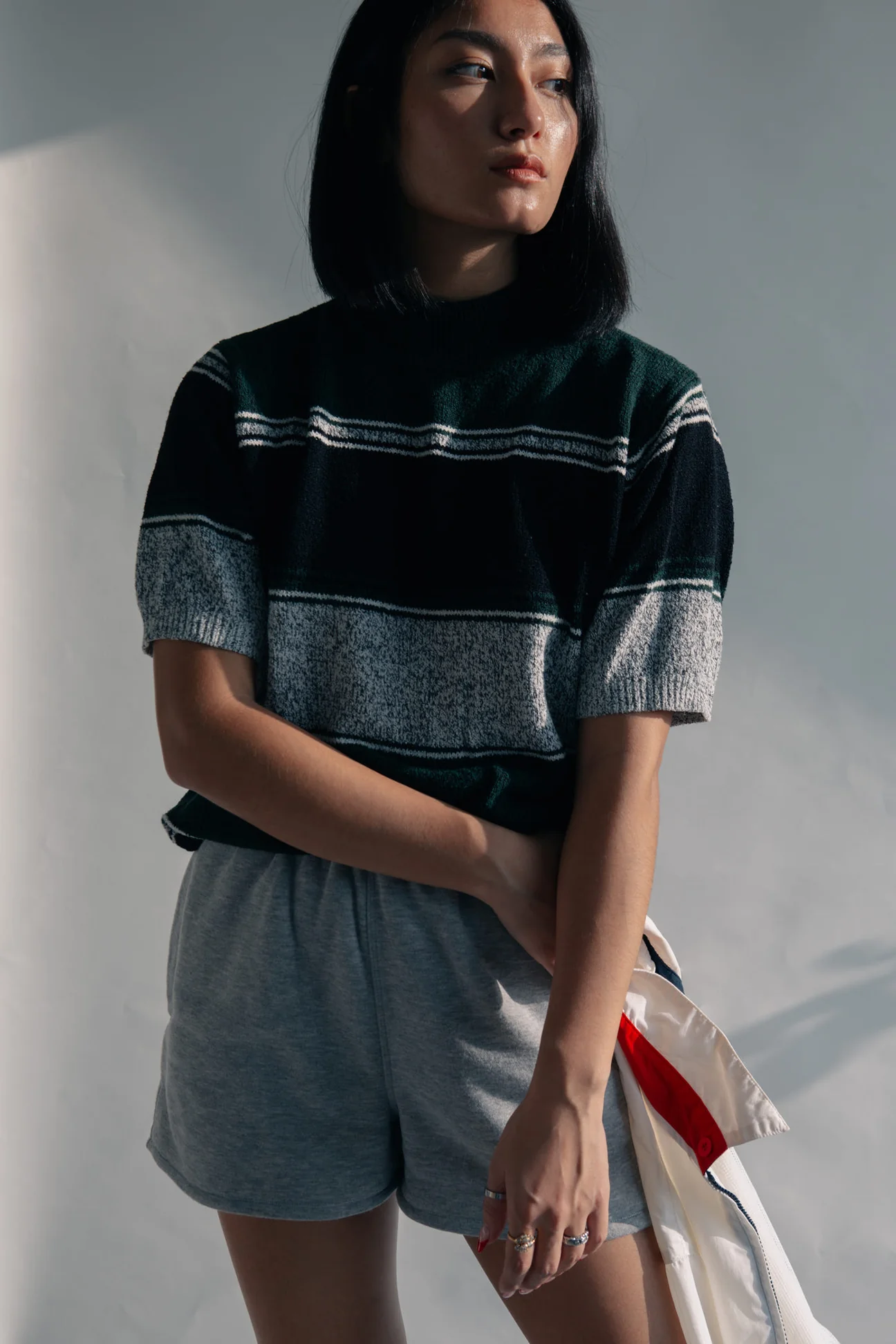 Woman in a black and ecru striped knitted tee