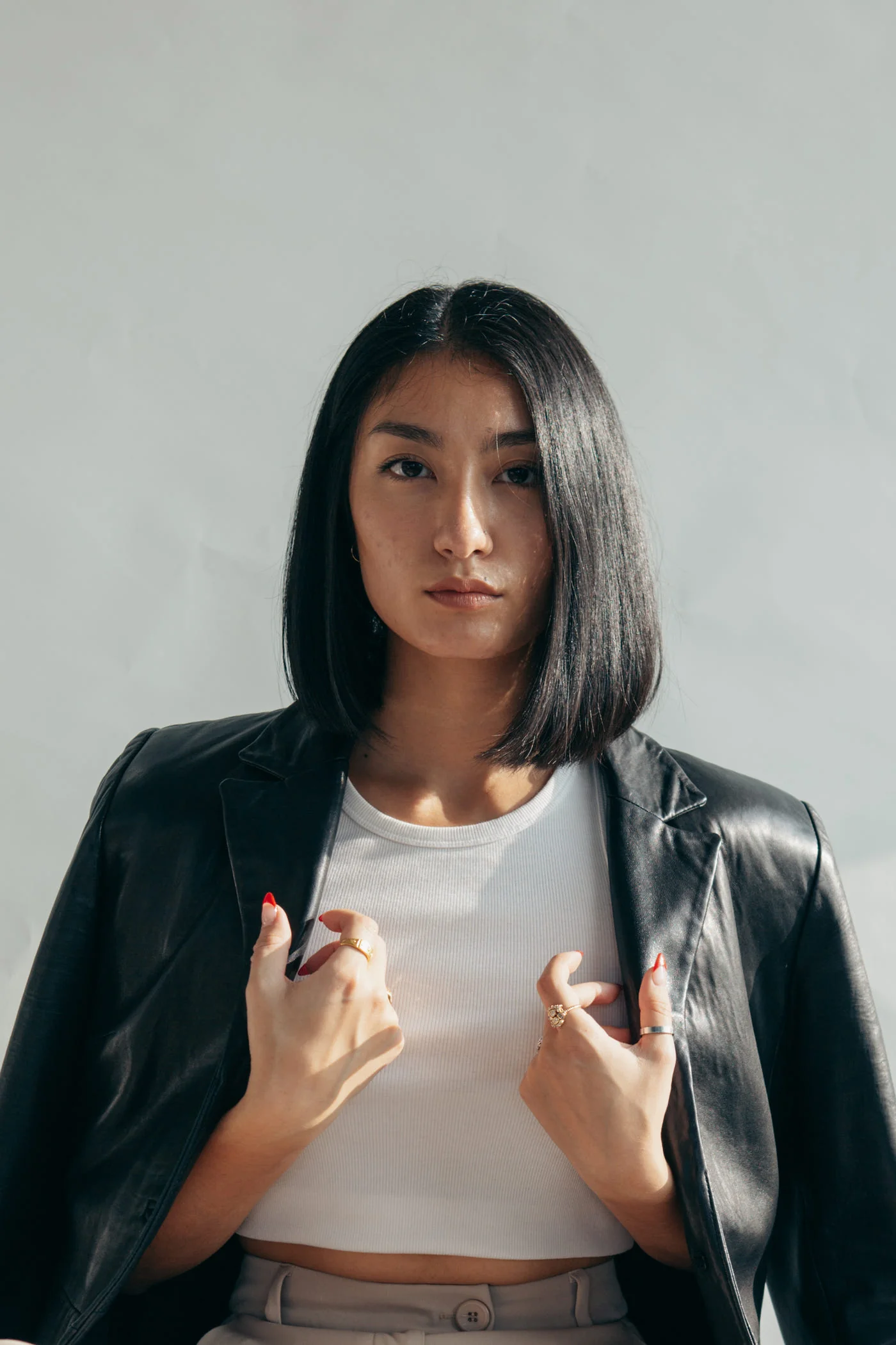 Woman with a black leather jacket over her shoulders